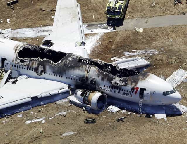 This aerial photo shows the wreckage of the Asiana Flight 214 airplane after it crashed at the San Francisco International Airport in San Francisco, Saturday, July 6, 2013. (Photo by Marcio Jose Sanchez/AP Photo)