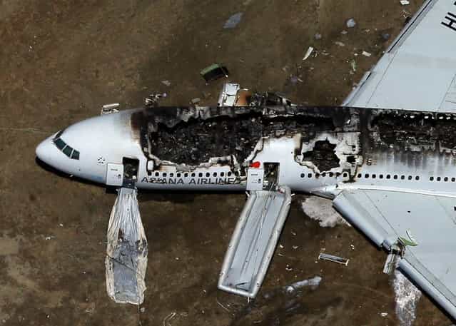 A Boeing 777 airplane lies burned on the runway after it crash landed at San Francisco International Airport July 6, 2013 in San Francisco, California. An Asiana Airlines passenger aircraft coming from Seoul, South Korea crashed while landing. There has been at least two casualties reported. (Photo by Ezra Shaw/Getty Images)