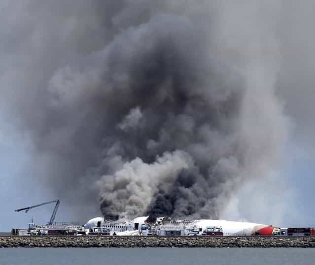 Fire crews are on the scene after an Asiana Airlines Boeing 777 crashed on landing at San Francisco International Airport in San Francisco, California, on Saturday, July 6, 2013. (Photo by John Green/Bay Area News Group/MCT)