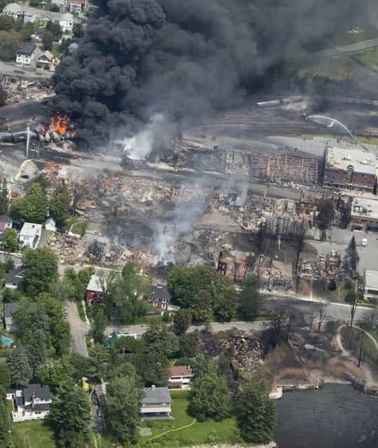 Destruction in Lac-Megantic cuts from the railyard to the waterfront, following a derailment and fire on July 6, 2013. (Photo by Paul Chiasson/AP Photo/The Canadian Press)