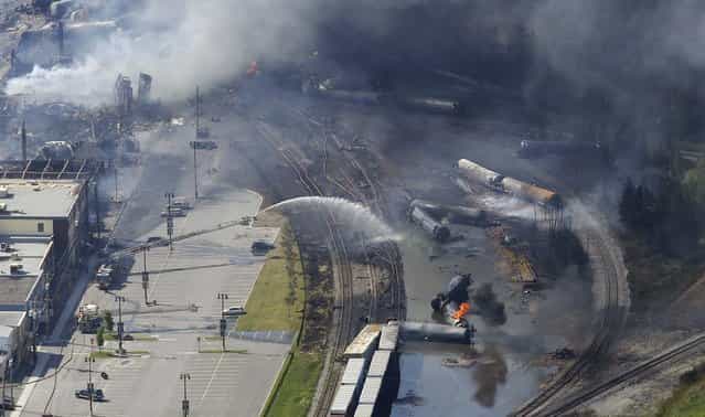 The wreckage of a train is pictured after an explosion in Lac Megantic July 6, 2013. Several people were missing after four tank cars of petroleum products exploded in the middle of a small town in the Canadian province of Quebec early on Saturday in a fiery blast that destroyed dozens of buildings. (Photo by Mathieu Belanger/Reuters)