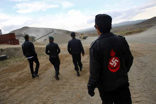 Members of the Mongolian neo-Nazi group Tsagaan Khass walk through a quarry, where they questioned a worker, southwest of Ulan Bator June 23, 2013. The group has rebranded itself as an environmentalist organisation fighting pollution by foreign-owned mines, seeking legitimacy as it sends Swastika-wearing members to check mining permits. Over the past years, ultra-nationalist groups have expanded in the country and among those garnering attention is Tsagaan Khass, which has recently shifted its focus from activities such as attacks on women it accuses of consorting with foreign men to environmental issues, with the stated goal of protecting Mongolia from foreign mining interests. This ultra-nationalist group was founded in the 1990s and currently has 100-plus members. (Photo by Carlos Barria/Reuters)