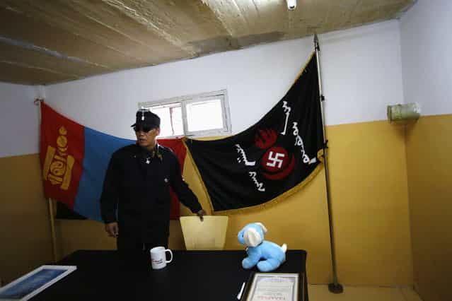 Ariunbold, a leader of the Mongolian neo-Nazi group Tsagaan Khass, arrives at the group's headquarters in Ulan Bator June 24, 2013. The group has rebranded itself as an environmentalist organisation fighting pollution by foreign-owned mines, seeking legitimacy as it sends Swastika-wearing members to check mining permits. Over the past years, ultra-nationalist groups have expanded in the country and among those garnering attention is Tsagaan Khass, which has recently shifted its focus from activities such as attacks on women it accuses of consorting with foreign men to environmental issues, with the stated goal of protecting Mongolia from foreign mining interests. This ultra-nationalist group was founded in the 1990s and currently has 100-plus members. (Photo by Carlos Barria/Reuters)