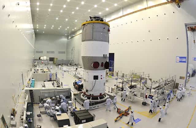 Researchers test China's first space station module Tiangong-1 inside the Jiuquan Satellite Launch Center in northwest China's Gansu Province, on the edge of the Gobi Desert. China launched the experimental module on September 29, 2011, to lay the groundwork for a future space station underscoring its ambitions to become a major space power. (Photo by AP Photo via The Atlantic)