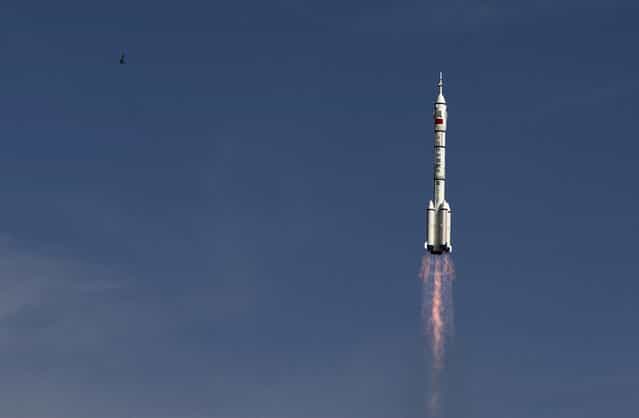 The Long March 2F rocket carrying the Shenzhou 10 capsule blasts off from the Jiuquan Satellite Launch Center, in Jiuquan, northwest China's Gansu Province, on June 11, 2013. The Shenzhou 10 capsule carrying three astronauts lifted off on a 15-day mission to dock with a space lab and to educate young people about science. (Photo by Andy Wong/AP Photo via The Atlantic)
