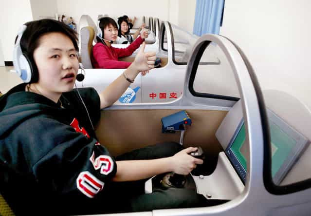 Zhang An (front) and other Chinese women take part in a test held by China's air force in Lanzhou, Gansu province, in March of 2005. China's air force selected around 30 women pilots including Zhang An, some of whom are reportedly intended to be future astronauts. They will embark on a space mission no later than 2010, working as flight commanders or on-board engineers, an official with China's space program announced. (Photo by Reuters/China Newsphoto via The Atlantic)