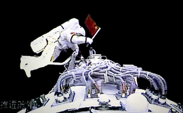 In this video grab taken at the Beijing Space Command and Control Center released by China's Xinhua News Agency, Saturday, September 27, 2008, Chinese astronaut Zhai Zhigang steps outside the orbit module of the Shenzhou-7 spacecraft for a spacewalk. (Photo by AP Photo/Xinhua via The Atlantic)