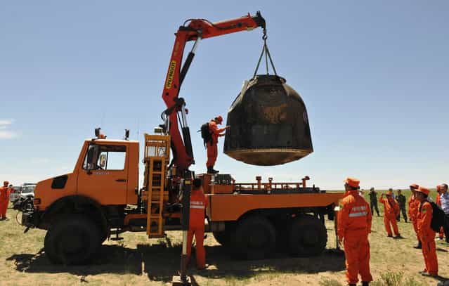 The re-entry capsule of China's Shenzhou-10 spacecraft is loaded onto a truck after it landed at in Inner Mongolia Autonomous Region, on June 26, 2013. (Photo by Reuters/China Daily via The Atlantic)