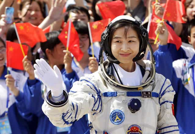 Liu Yang, China's first female astronaut, waves during a departure ceremony at Jiuquan Satellite Launch Center, on June 16, 2012. (Photo by Jason Lee/Reuters via The Atlantic)