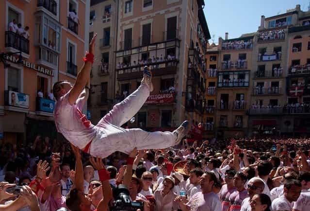 Revellers celebrate during the opening day of the San Fermin fiestas. (Photo by Pablo Blazquez Dominguez/Getty Images)
