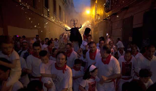 A Toro del Fuego (flaming bull) is run through the streets of Pamplona. (Photo by Pablo Blazquez Dominguez/Getty Images)
