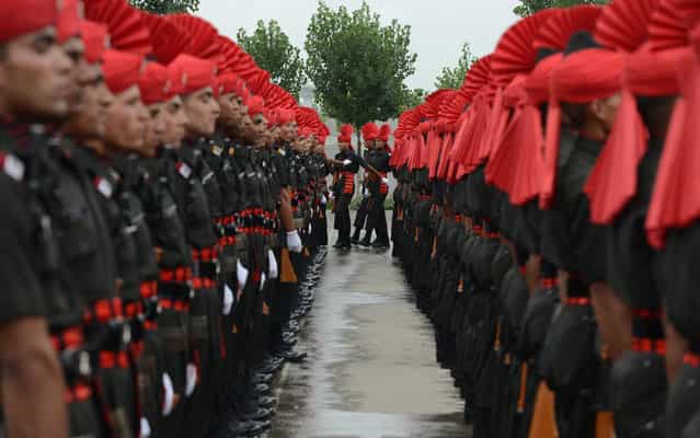 Recruits from the Jammu and Kashmir Light Infantry Regiment (JAKLI) of the Indian Army take part in a passing out parade in Srinagar on July 10, 2013. The 494 recruits, many of them locals, completed a 49-week training programme prior to being absorbed as regular members of the regiment. (Photo by Tauseef Mustafa/AFP Photo)