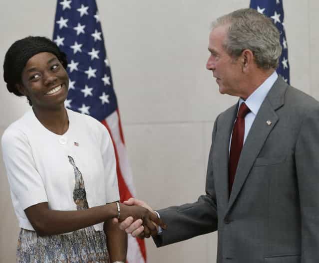 Former President George W. Bush, right, shakes hands with with Mondell Bernadette Avril after she was sworn in as a U.S. citizen during a ceremony at the The George W. Bush Presidential Center in Dallas, Wednesday, July 10, 2013. Twenty new citizens took the oath of U.S. citizenship at the former president's library. (Photo by L. M. Otero/AP Photo)