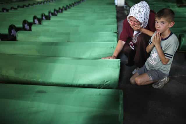 A Bosnian woman cries near the coffin of her relative, one of 409 newly identified victims of the 1995 Srebrenica massacre, in Memorial Center Potocari near Srebrenica July 10, 2013. The bodies of the recently identified victims will be transported to the memorial centre in Potocari where they will be buried on July 11 marking the 18th anniversary of the massacre in which Bosnian Serb forces commanded by Ratko Mladic killed up to 8,000 Muslim men and boys and buried them in mass graves. (Photo by Dado Ruvic/Reuters)