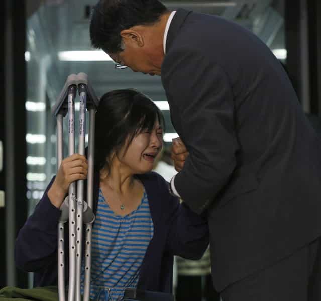 Kim Yoon-ju (L), a flight attendant who was on Asiana Airlines flight 214 which crashed in San Francisco, cries as she is greeted by Park Sam-koo, chairman of the Kumho-Asiana group, as she arrives at the Incheon Airport in Incheon, west of Seoul July 11, 2013. Asiana Airlines Flight 214 crashed in San Francisco on Saturday, killing two teenage girls and injuring more than 180 people. (Photo by Kim Hong-Ji/Reuters)