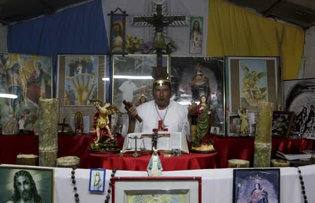 Hermes Cifuentes, who is also known as [Brother Hermes], prays after performing an exorcism on Gisela Marulanda, 23, who claims to be possessed by spirits in La Cumbre, Valle July 7, 2012. Cifuentes says he has performed more than 35,000 exorcism rituals in the past 25 years. Picture taken July 7, 2012. REUTERS/Jaime Saldarriaga (COLOMBIA - Tags: SOCIETY RELIGION)