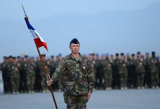 French soldiers stand guard during a ceremony for the French National Day, Bastille Day, at Kabul International Airport in Kabul on July 13, 2013. The French contingent in Afghanistan held a ceremony in Kabul to mark Bastille Day that is held on July 14. France has 500 soldiers in Afghanistan. (Photo by Massoud Hossaini/AFP Photo)
