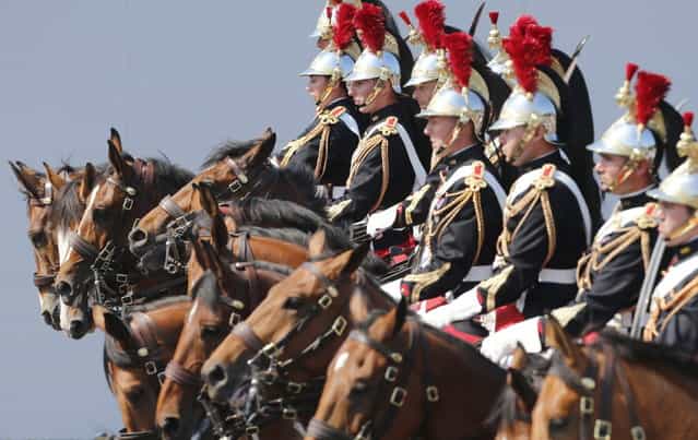 French Republican horse Guards parade during the Bastille Day in Paris Sunday, July 14, 2013. (Photo by Jacques Brinon/AP Photo)