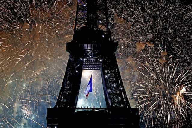 The Eiffel Tower is illuminated during the traditional Bastille Day fireworks display, on July 14, 2013. (Photo by Charles Platiau/Reuters)