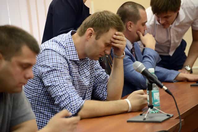 Russian opposition figure, Alexei Navalny (R), reacts as the court delivers the verdict in his trial, in the city of Kirov, Russia, 18 July 2013. Russian opposition leader Alexei Navalny was found guilty of embezzlement on 18 July by a city court, news agencies reported. The sentence was expected to be handed down after the judge finished reading the verdict later in the day. In the politically charged trial, Navalny was accused of stealing 500,000 dollars worth of timber from a state enterprise while serving as a regional government adviser in Kirov, a city 800 kilometres east of Moscow, where the court was also located. Prosecutors have asked for Navalny to be sentenced to six years in a labour camp. Navalny denied the charges and has called the trial politically motivated. (Photo by Valentina Svistunova/EPA)