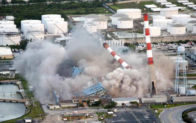 Four 350-feet-tall smoke stacks and boilers are demolished by Florida Power and Light Company (FPL) at its Port Everglades power plant in Hollywood, Florida,July 16, 2013 in this picture provided by Florida Power and Light Company. The demolition was done to make way for a new, high-efficiency, clean power plant. Scheduled to open in 2016, the new, state-of-the-art combined-cycle natural gas plant will produce enough electricity to power approximately 260,000 homes while using 35 percent less fuel than the old power plant, according to FPL. (Photo by Brian Blanco/Reuters/Florida Power and Light)