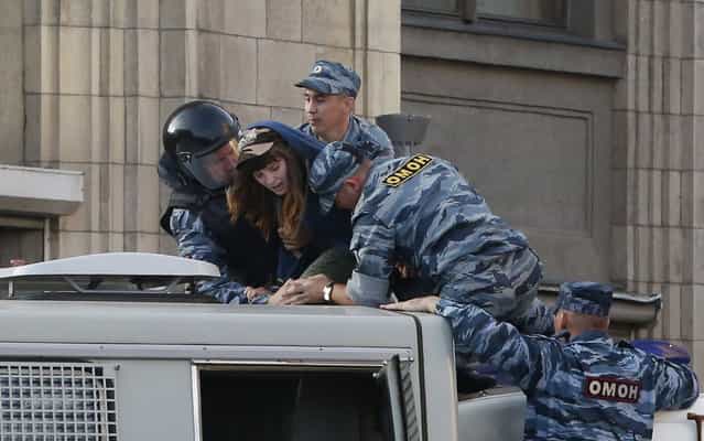 Policemen detain a woman on a police truck during a protest against the verdict of a court in Kirov, which sentenced Russian opposition leader Alexei Navalny to five years in jail, in central Moscow, July 18, 2013. Russian opposition leader Alexei Navalny was sentenced to five years in jail for theft on Thursday, an unexpectedly tough punishment which supporters said proved President Vladimir Putin was a dictator ruling by repression. (Photo by Grigory Dukor/Reuters)