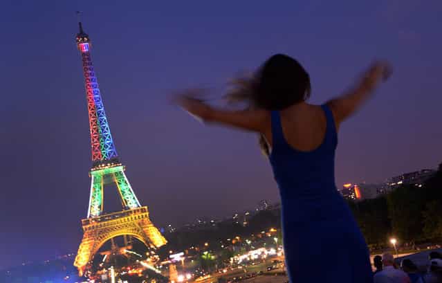 The Eiffel Tower in Paris is floodlit in the colours of the South African flag on July 18, 2013 in honour of Mandela Day, the birthday of Nelson Mandela. (Photo by Pierre Andrieu/AFP Photo)