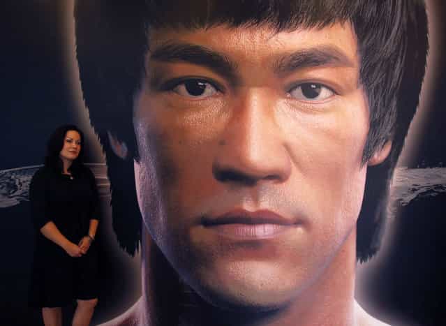 Shannon Lee, daughter of the late Kung Fu legend Bruce Lee, poses beside a portrait of her father at the Hong Kong Heritage Museum, before the start of a five-year exhibition on Lee, July 18, 2013. Late kung fu superstar Bruce Lee may be an international icon, but he is still not the complete local hero in Hong Kong. Fans are marking his death 40 years ago this weekend with art gallery shows, exhibitions and even street graffiti but some people are urging Hong Kong's government to do more to honour the former British colony's biggest star. (Photo by Bobby Yip/Reuters)