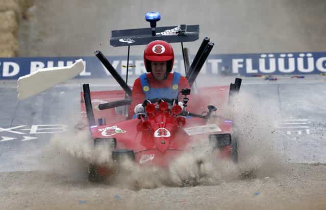 German three-time Red Bull Formula One world champion Sebastian Vettel loses a wing as he lands a jump during a soapbox fun race in the western German town of Herten, near Gelsenkirchen, July 14, 2013. (Photo by Wolfgang Rattay/Reuters)