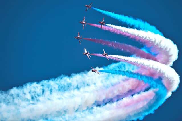 The Royal Air Force Red Arrows Display Team perform at RAF Fairford, Wiltshire, ahead of the Royal International Air Tattoo July 19, 2013. (Photo by Ben Birchall/PA Wire)