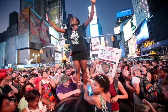Trayvon Martin supporters rally in New York City's Times Square after marching from a rally in Union Square July 14, 2013. The action came after George Zimmerman was acquitted July 13 of all charges in the February 2012 shooting death of Martin. (Photo by Mario Tama/Getty Images)