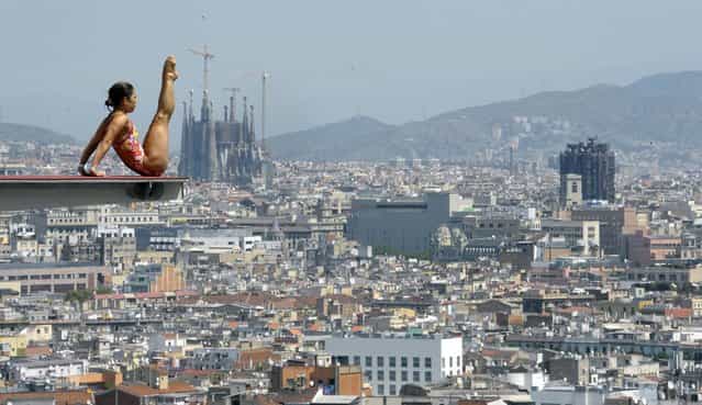 The Sagrada Familia cathedral is seen in the background as an unidentified diver practices ahead of the FINA World Championships in Barcelona, Spain, Monday, July 15, 2013. The FINA swimming World Championships run from July 19 to August 4 in Barcelona. (Photo by Manu Fernandez/AP Photo)
