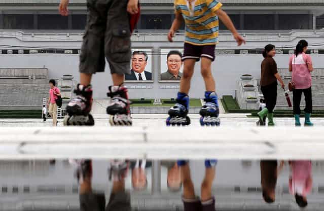 Children skate around the Kim Il Sung Square on Sunday, July 21, 2013, downtown Pyongyang, North Korea. The country is preparing to mark the 60th anniversary of the end of the Korean War. (Photo by Wong Maye-E/AP Photo)