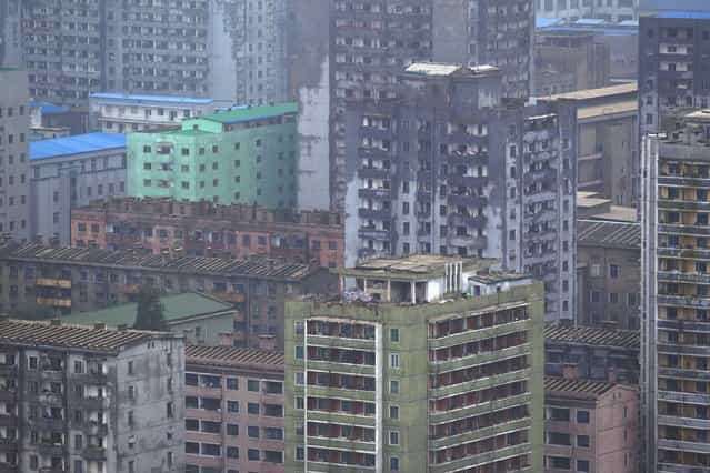 A North Korean building block stands along the Taedong River in central Pyongyang on Tuesday, July 23, 2013. (Photo by David Guttenfelder/AP Photo)