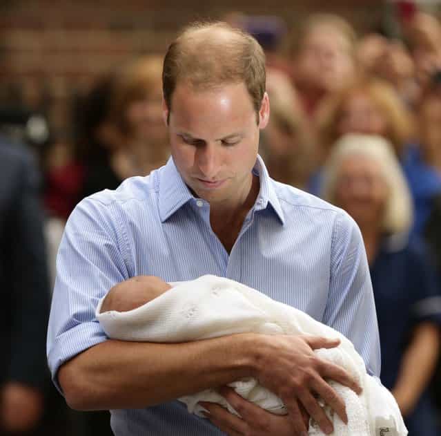 The Duke of Cambridge leaves the Lindo Wing of St Mary's Hospital in London Tuesday July 23 2013, carrying his new-born son, the Prince of Cambridge, who was born Monday, into public view for the first time. The boy will be third in line to the British throne. (Photo by Yui Mok/AP Photo/PA)