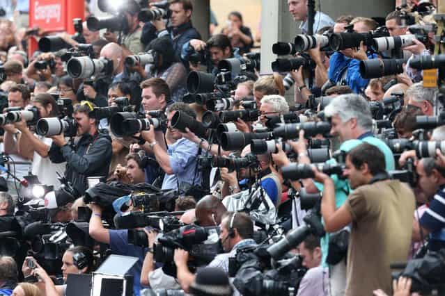 The massed ranks of the media capture the moment the Duke and Duchess of Cambridge leave the Lindo Wing of St Mary's Hospital in London, with their newborn son Tuesday July 23 2013. (Photo by Steve Parsons/AP Photo/PA)
