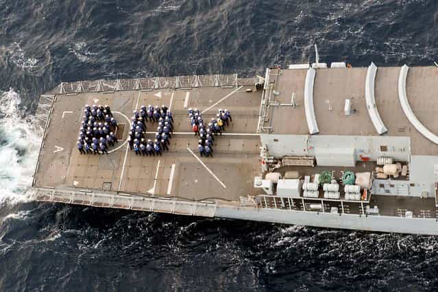 Ministry of Defence photo of HMS Lancaster as it celebrates the Royal Birth of the Duke and Duchess of Cambridge's child whilst on patrol in the Caribbean, on July 23, 2013. The ships company spelt out the word BOY on the ships flight deck sending their best wishes and congratulations to the royal couple. Photo by Jay Allen/PA Wire)