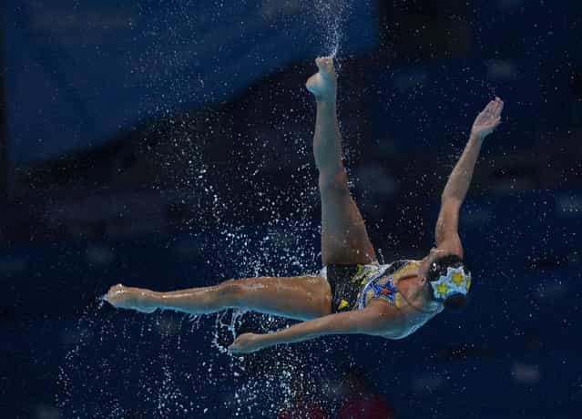 A Mexican swimmer is airborne as her team performs their routine in the synchronised swimming free combined event event at the FINA Swimming World Championships in Barcelona, Spain, Sunday, July 21, 2013. (Photo by Manu Fernandez/AP Photo)
