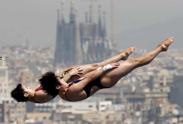 China's Chen Roulin, right, and Liu Huixia perform during a synchronized 10-meter platform diving training session ahead of the FINA Swimming World Championships in Barcelona, Spain, Friday, July 19, 2013. In the background is the Sagrada Familia church. (Photo by Michael Sohn/AP Photo)