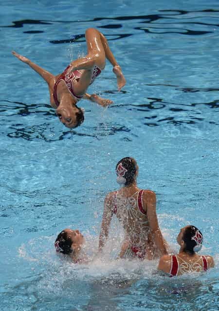 Spain's synchronised swimming team compete in the team free preliminary round during the synchronised swimming competition in the FINA World Championships at the Palau Sant Jordi in Barcelona, on July 23, 2013. (Photo by Lluis Gene/AFP Photo)