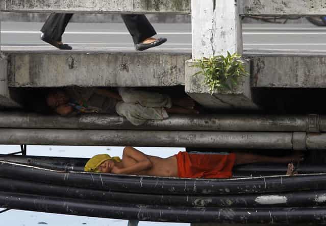 Street children sleep under a bridge in Paranaque city, metro Manila July 18, 2013. Picture taken July 18, 2013. (Photo by Romeo Ranoco/Reuters)
