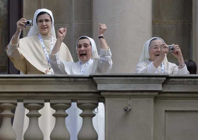 Nuns celebrate and take pictures as Pope Francis arrives to give the Angelus noon prayer in Rio de Janeiro on July 26, 2013. (Photo by Luca Zennaro/Associated Press)