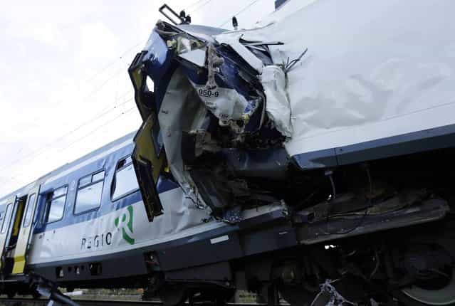 A view of the scene where two Swiss regional trains collided head on near Granges-Pres-Marnand near Payerne in western Switzerland July 29, 2013. The two trains collided in the Swiss canton of Vaud on Monday evening, injuring about 40 people, four seriously, Swiss news agency ATS reported. There was no immediate report of any deaths in the crash. (Photo by Denis Balibouse/Reuters)