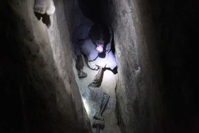 A gold mine worker looks for gold inside a local mine in Al-Ibedia locality at River Nile State, July 30, 2013. (Photo by Mohamed Nureldin Abdallah/Reuters)