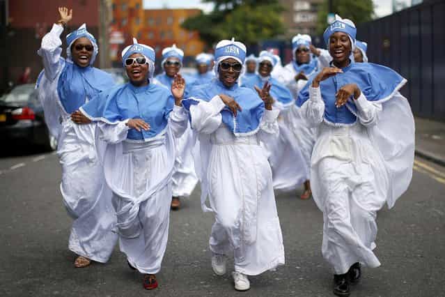 Members of the Eternal Sacred Order of the Cherubim and Seraphim Church choir march through Walworth as part of their annual Thanksgiving service in London, on July 31, 2013. (Photo by Dan Kitwood/Getty Images)