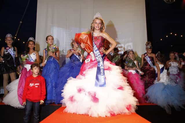 The winners celebrate on stage during the [mini-miss] beauty contest in Bobigny, Paris suburb, September 22, 2012. The competition is open for girls aged 7 to 12. (Photo by Benoit Tessier/Reuters)
