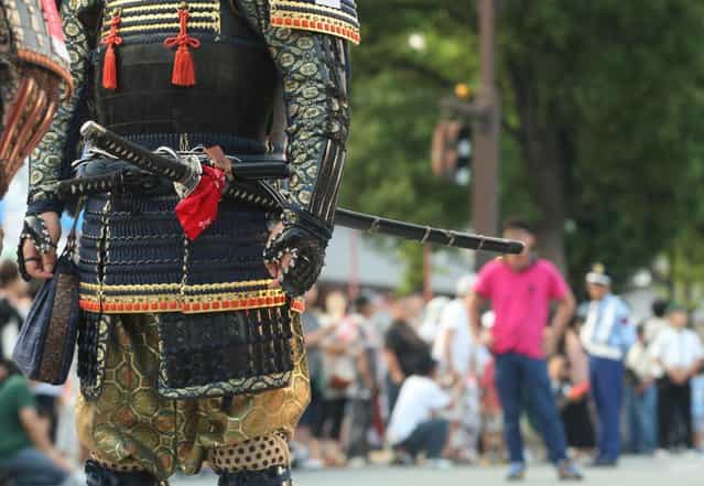 A man dressed in Samurai costume and sword march during the annual Himeji Castle Festival on August 3, 2013 in Himeji, Japan. The parade of Castle Queens is part of the traditional matsuri festival around the UNESCO world heritage Himeji Castle. (Photo by Buddhika Weerasinghe/Getty Images)