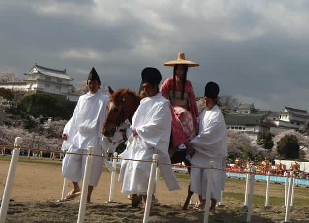 A woman wears tradional costume ride by horse for entertain the gods during the Mitsuyama Taisai Festival of Itate Hyozu Shrine at front of the Himeji castle on April 3, 2013 in Himeji, Japan. (Photo by Buddhika Weerasinghe/Getty Images)