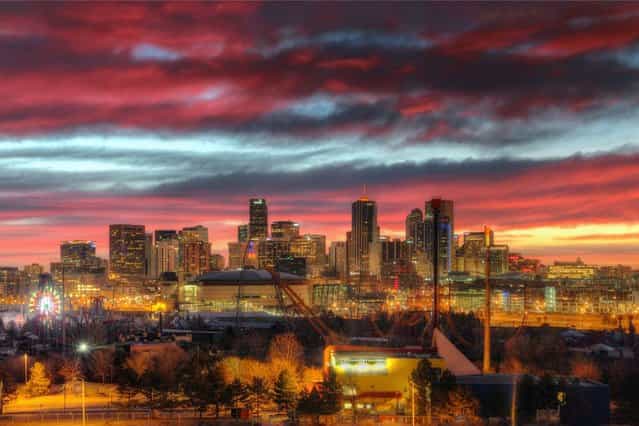 A red sky rises over the city of Denver, Colorado. (Photo by Greg Thow/Barcroft Media)