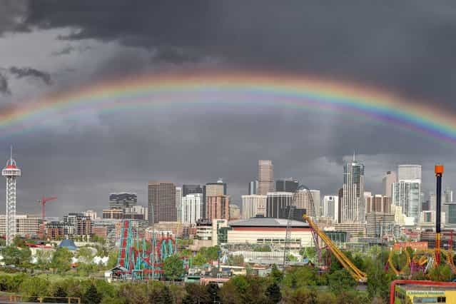 A wide view of a huge rainbow stretching over the city of Denver in Colorado. (Photo by Greg Thow/Barcroft Media)